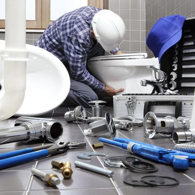 plumber at work in a bathroom, plumbing repair service, assemble and install concept